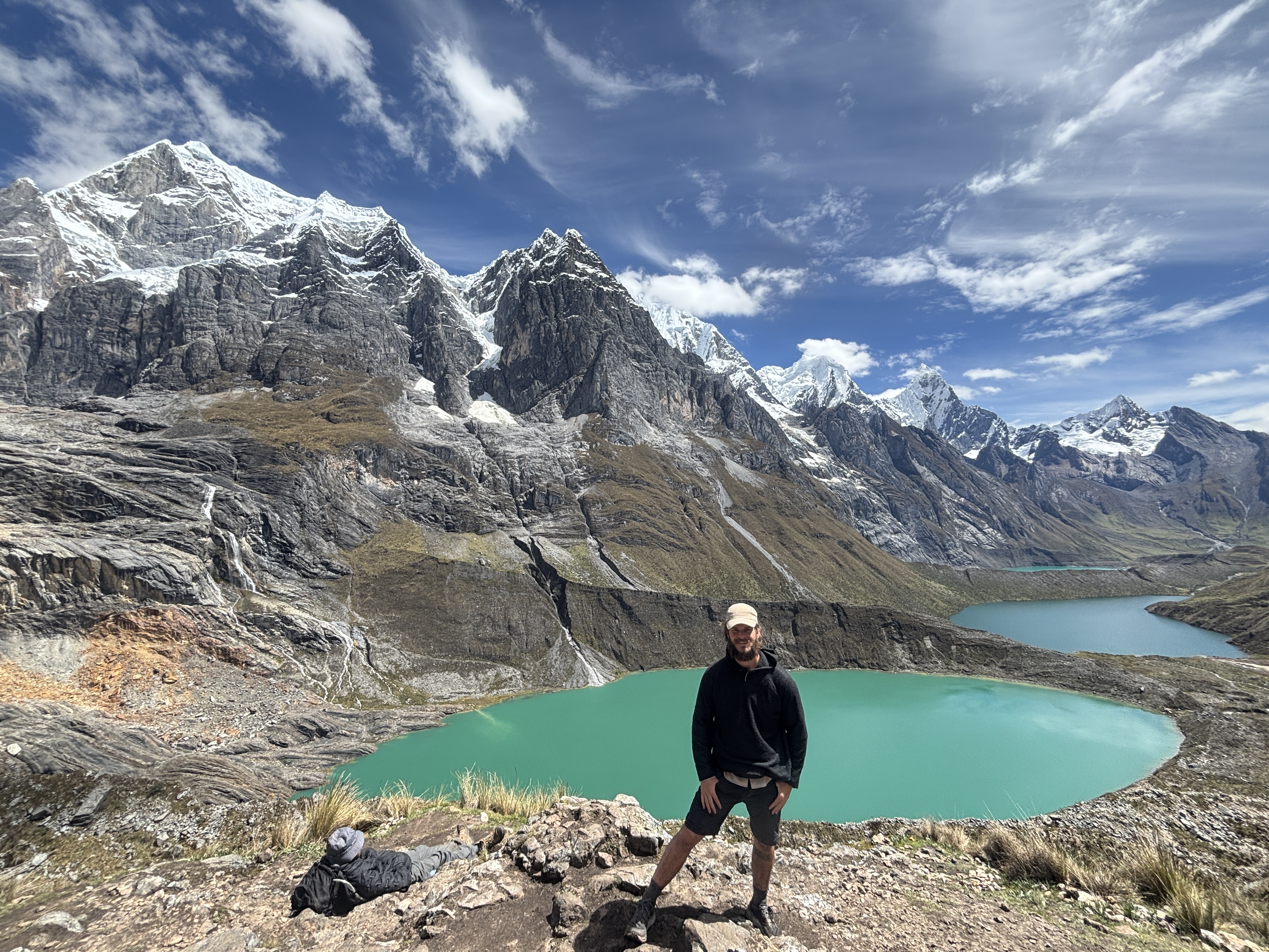Simon Lusignan overlooking a turquoise glacial lake in the Cordillera Huayhuash, the kind of high-stakes trail you're training for